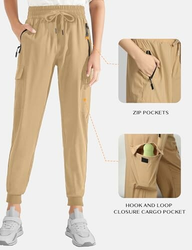 Beige cargo joggers with zip and hook-and-loop pockets.