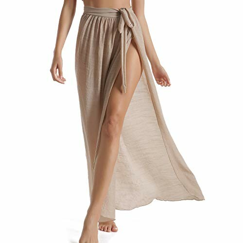 Woman wearing a beige wrap beach skirt with side slit.