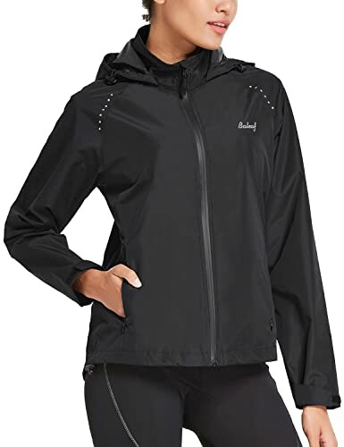 Woman wearing a black hooded jacket with zipper