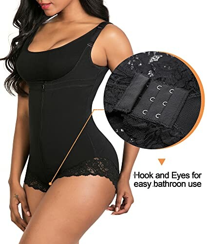 Woman wearing a black lace bodysuit with hook and eye closure.