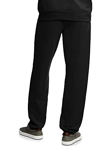Person wearing black sweatpants and gray shoes, back view.