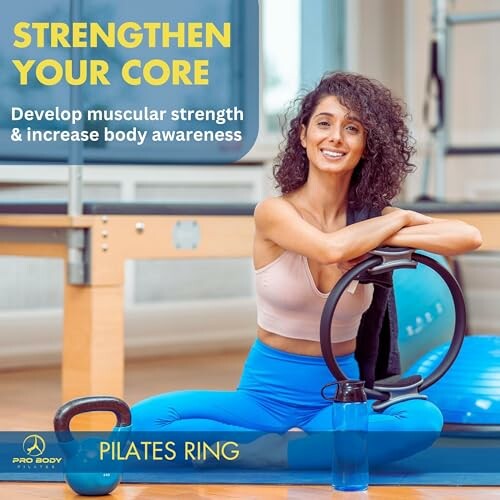 Woman sitting with a pilates ring in a gym promoting core strength.