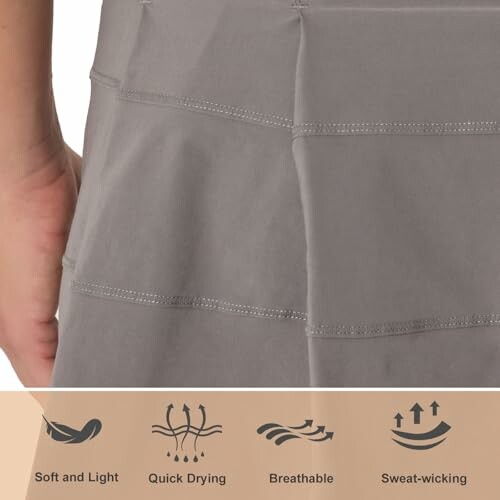 Gray athletic skirt showing features: soft, quick drying, breathable, sweat-wicking.