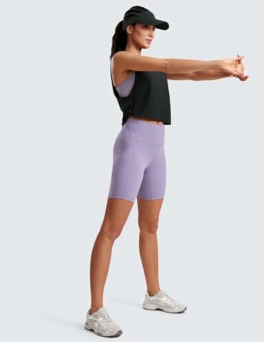 Woman in athletic wear stretching her arms.