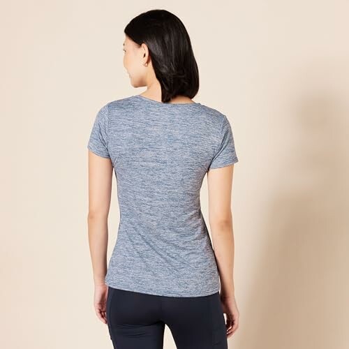Woman wearing a blue t-shirt, viewed from the back.