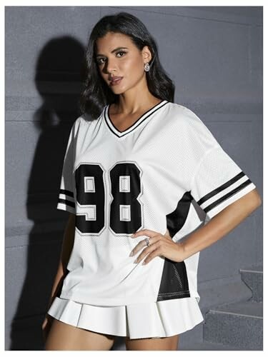 Woman in a white sports jersey with the number 98.
