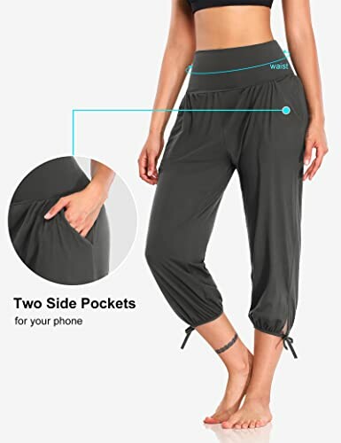 Woman wearing black yoga pants with side pockets.